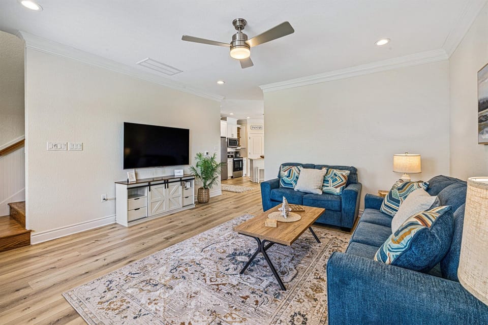 Inviting living room with smart TV opens to kitchen and dining room