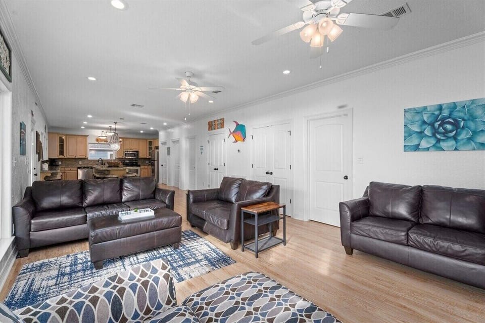 Wide-angle living room with ample seating, entertainment center, and open layout ideal for large groups.