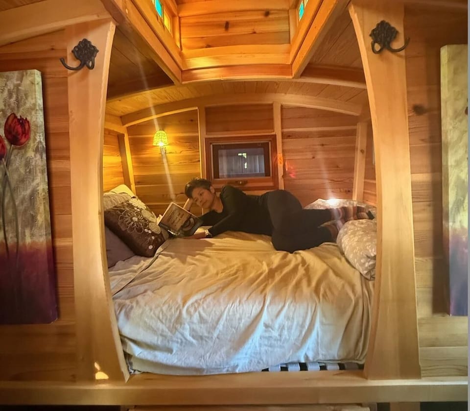 Cozy bedroom retreat with warm wood accents and skylight