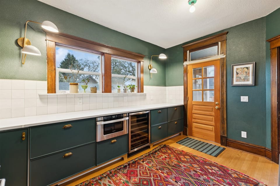 Kitchen with wine fridge, and microwave drawer as well as access to backyard.