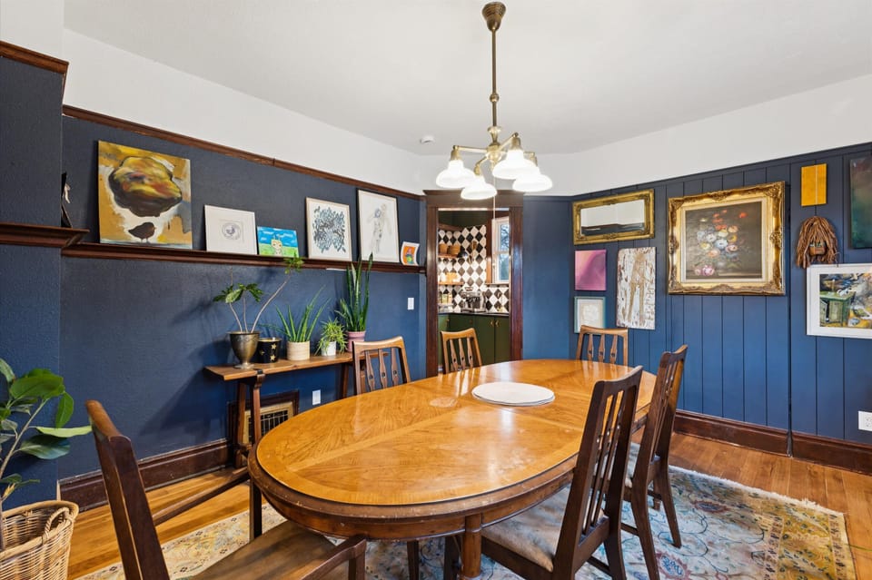 Dining room with access to half bath behind flower painting.