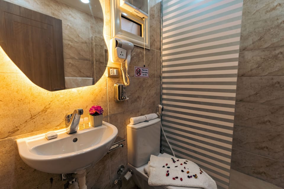 Shower, designer toiletries, hair dryer, bathrobes