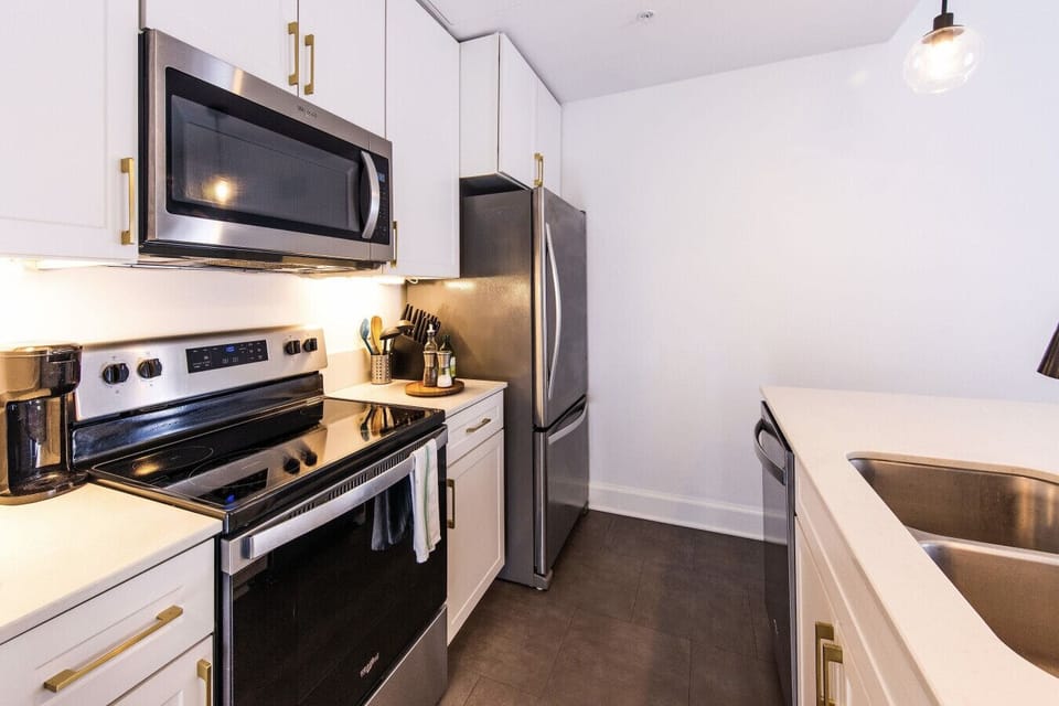 A fully-equipped kitchen featuring high-end finishes and bar seating—everything you need to prep, cook, and refuel