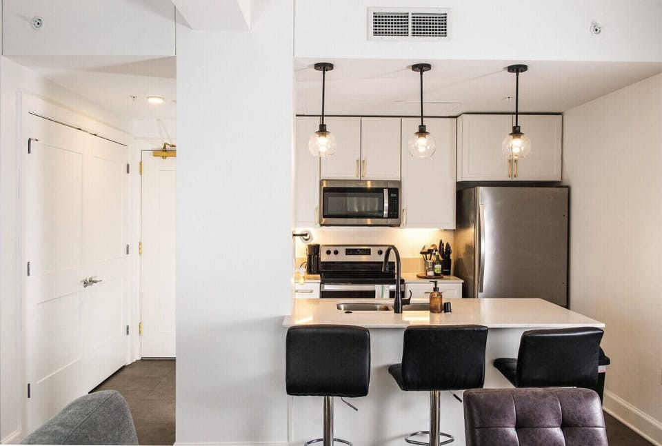 A fully-equipped kitchen featuring high-end finishes and bar seating—everything you need to prep, cook, and refuel