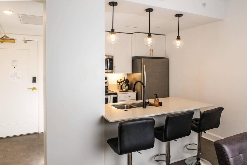 A fully-equipped kitchen featuring high-end finishes and bar seating—everything you need to prep, cook, and refuel