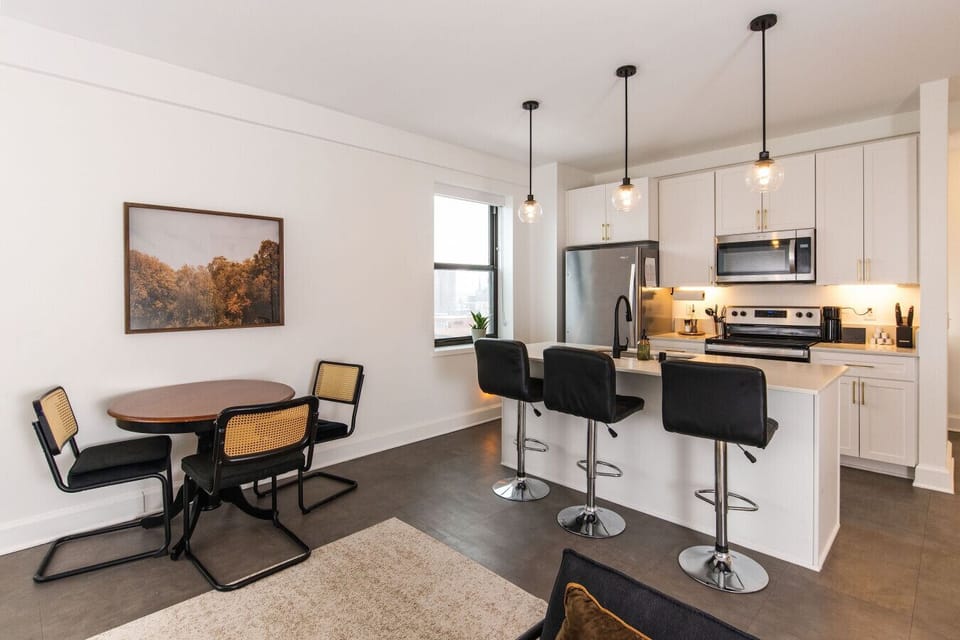 A fully-equipped kitchen featuring high-end finishes and bar seating—everything you need to prep, cook, and refuel