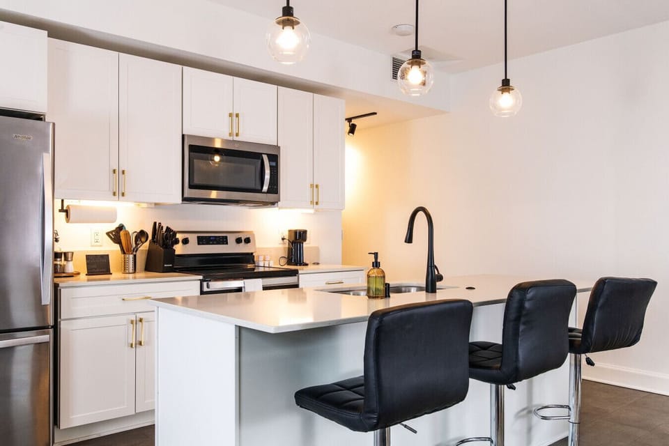 A fully-equipped kitchen featuring high-end finishes and bar seating—everything you need to prep, cook, and refuel