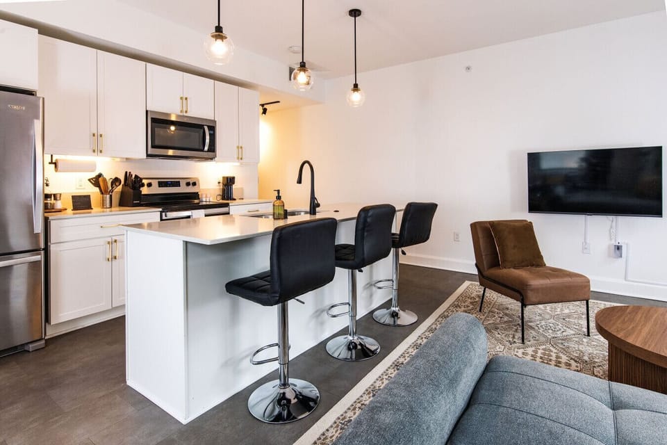 A fully-equipped kitchen featuring high-end finishes and bar seating—everything you need to prep, cook, and refuel