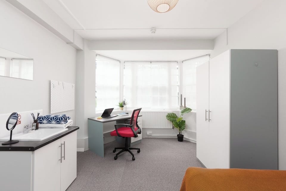 Private bedroom with working space and private sink