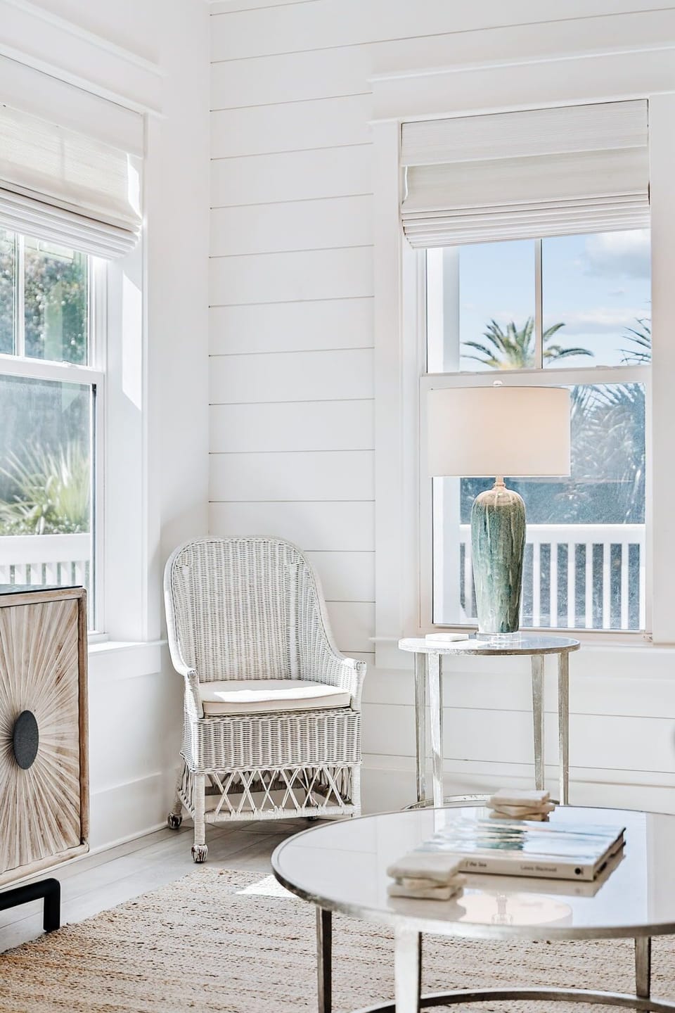 Spacious, open-concept living area filled with natural light, featuring ample seating and seamless flow to the kitchen and outdoor pool area.