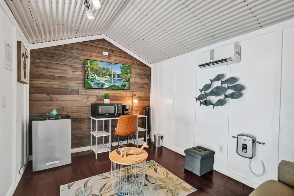 Poolside casita with sofa bed, TV, and kitchenette.
