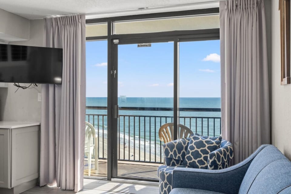 Relax in this inviting oceanfront living room with a comfy sleeper sofa and private balcony. Take in panoramic views of North Myrtle Beach and the sparkling pools below.  It`s your perfect spot to unwind and embrace the coastal resort vibe