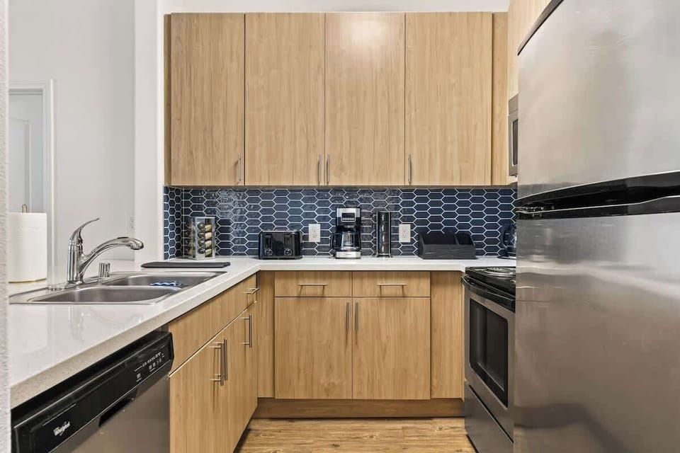 Compact yet elegant kitchen, complete with full-size refrigerator, oven, and dishwasher for ultimate convenience.