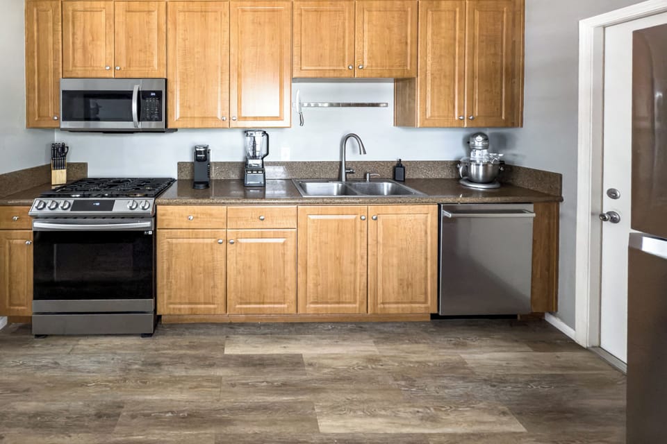 Kitchen with Dishwasher, Microwave, Coffee Maker and Blender.