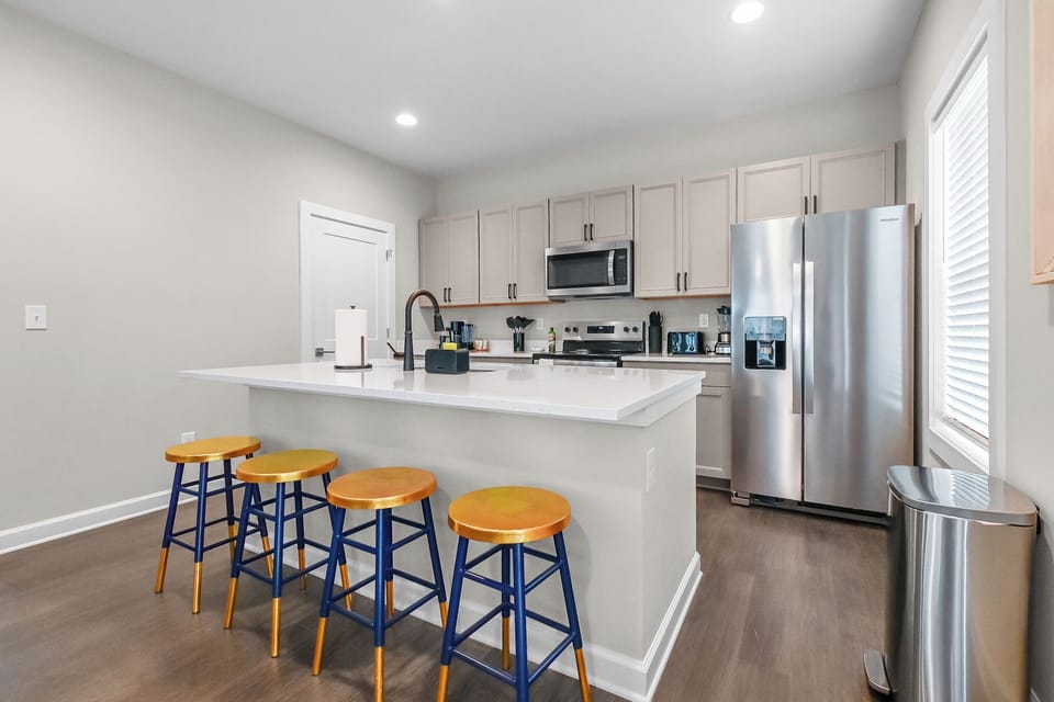 Modern kitchen with new appliances and spacious island, counter for 4 people 