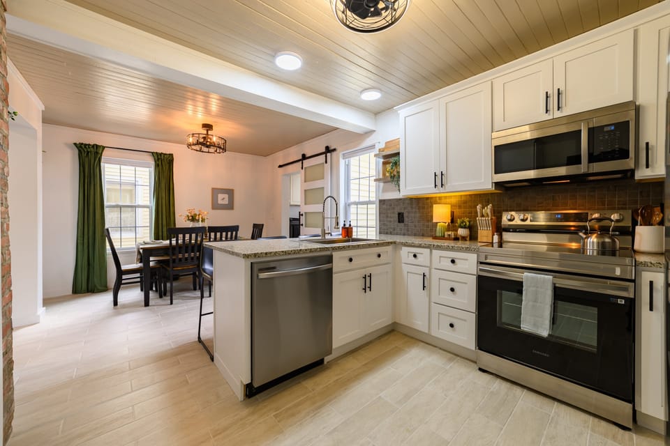 Modern kitchen equipped with cookware, bakeware, small appliances, and all essentials for cooking and entertaining.
