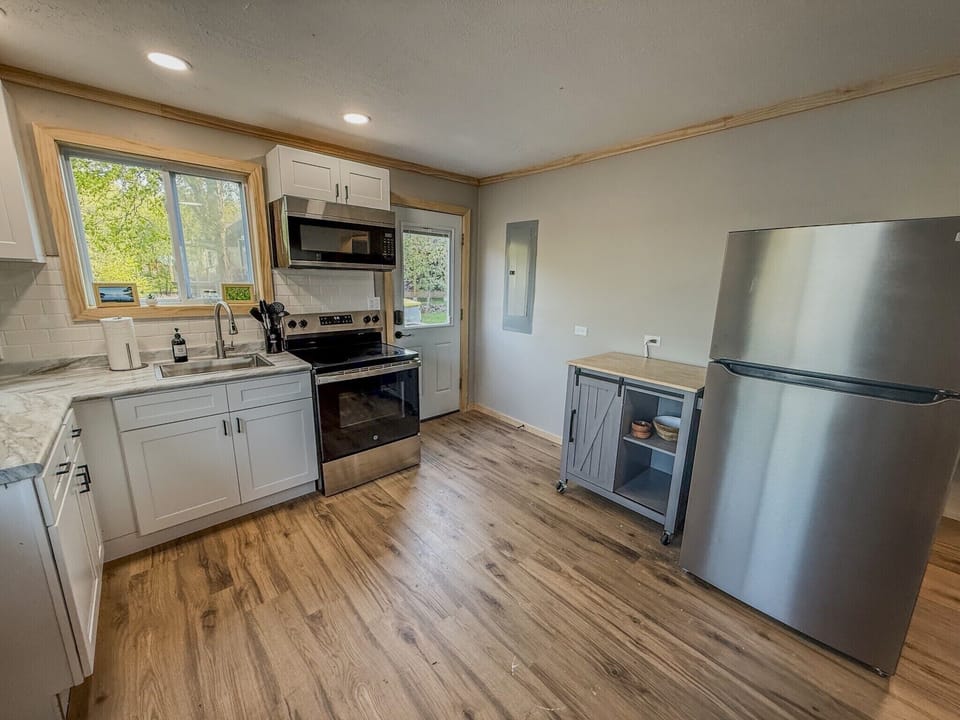 Bright modern kitchen with stainless appliances and natural light
