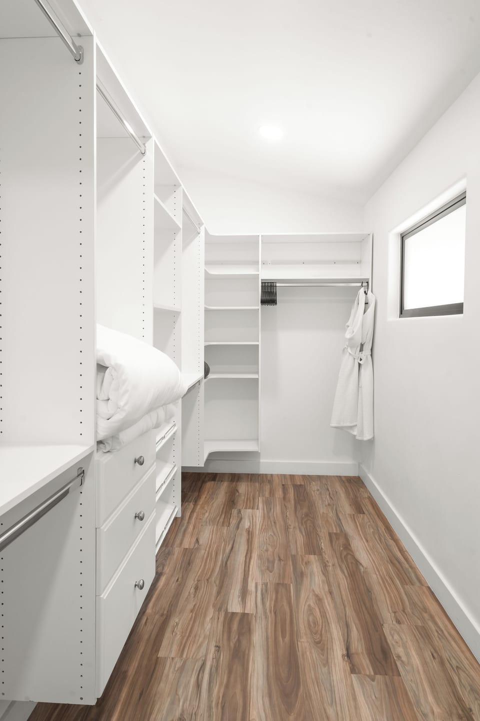 View of the large primary bedroom walk-in closet.