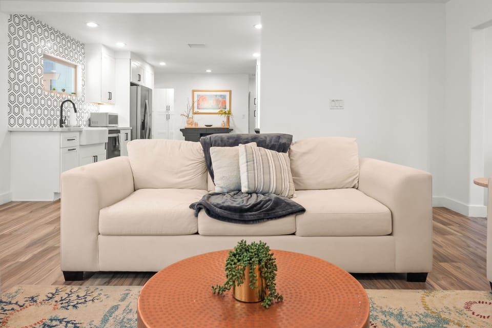 View from the open concept living room to the fully remodeled modern kitchen.