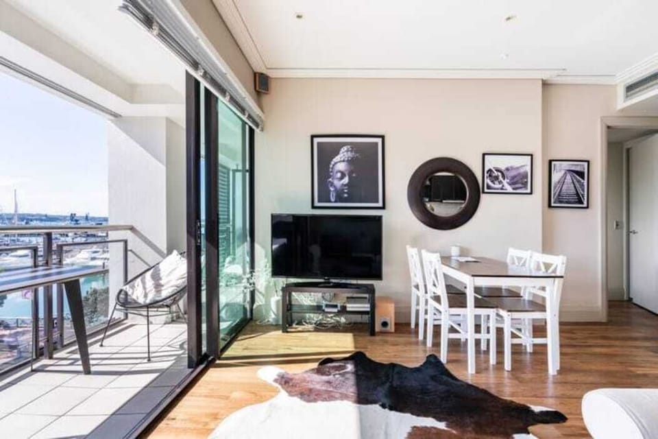 Contemporary lounge with flat-screen TV and direct access to the scenic balcony