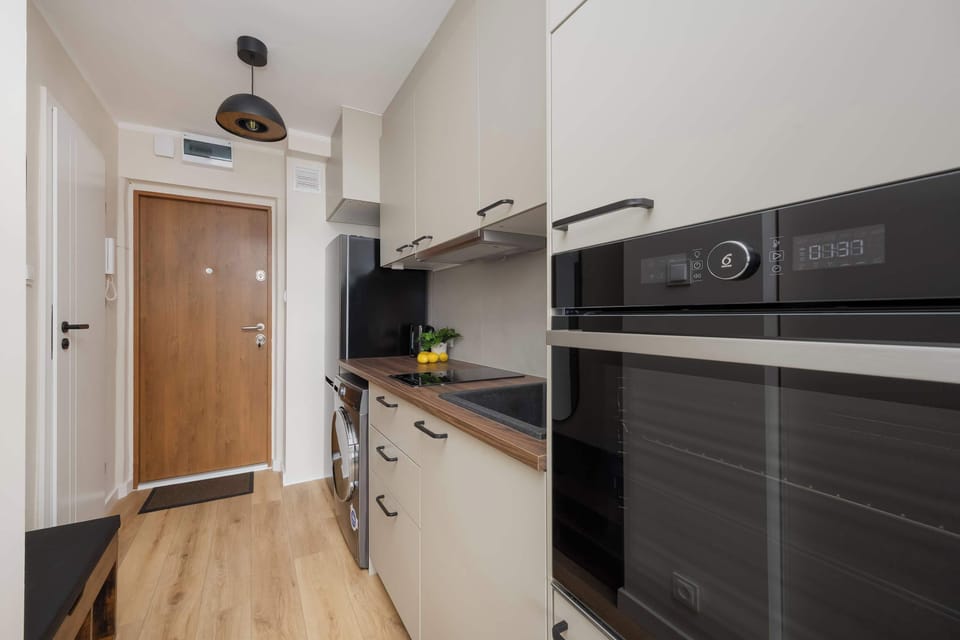 Hallway leading into the kitchen, decorated in a bright, minimalist tone.