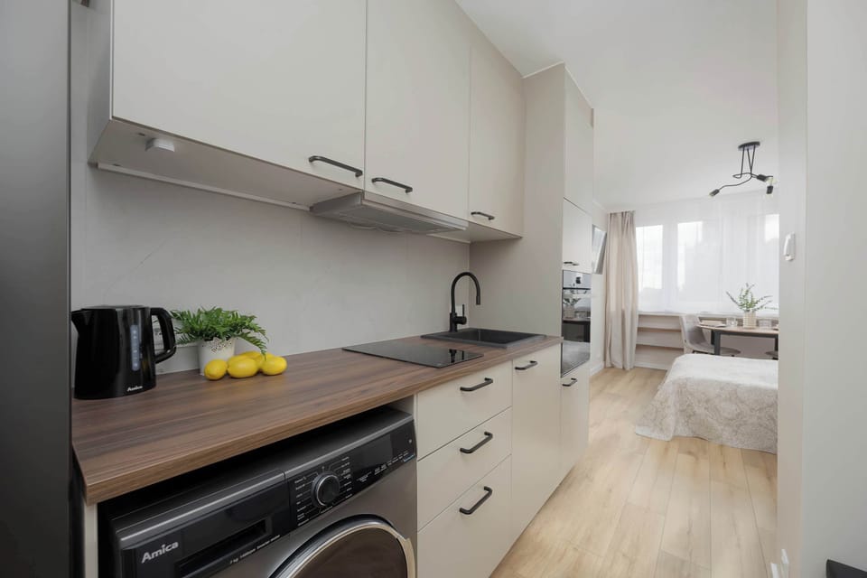 Fully equipped kitchenette with modern finishes and under-cabinet lighting.