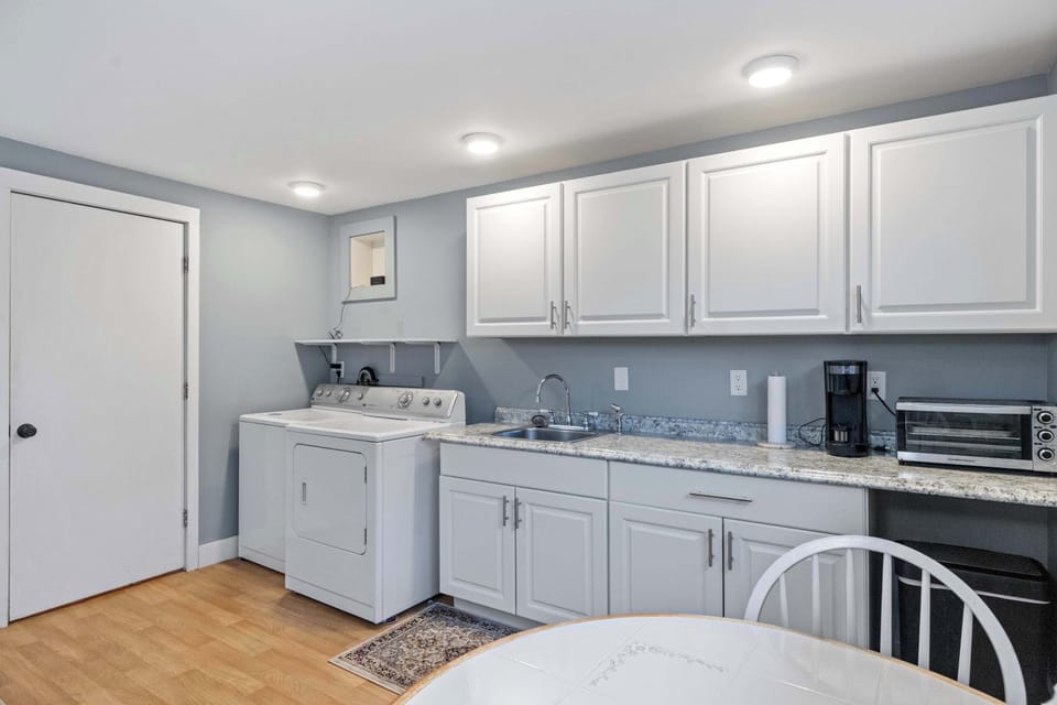 Fully equipped kitchen with modern appliances, coffee maker, and all the essentials for home-cooked meals.