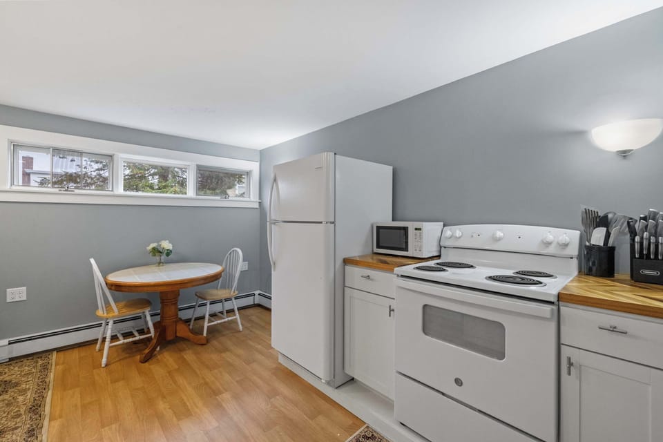 Kitchen and dining area with full-size stove, refrigerator, and breakfast nook for morning coffee or casual dining.