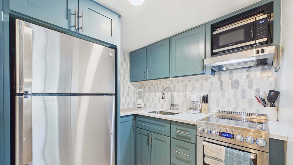 Fully applianced kitchen with full fridge and all the cooking essentials