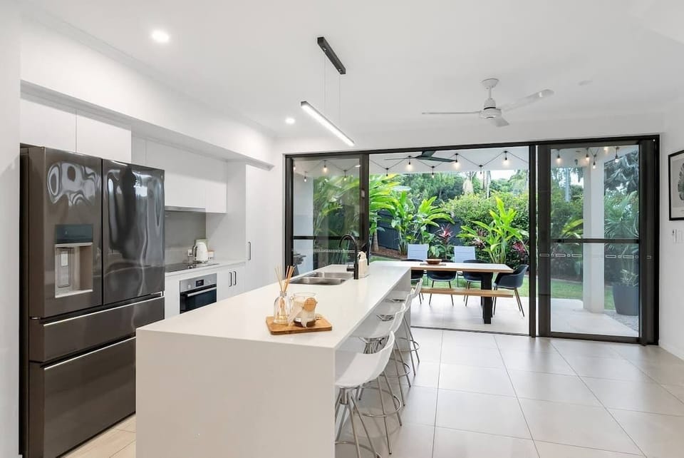 The full kitchen features a spacious island bench for easy breakfasts and casual conversations while cooking.