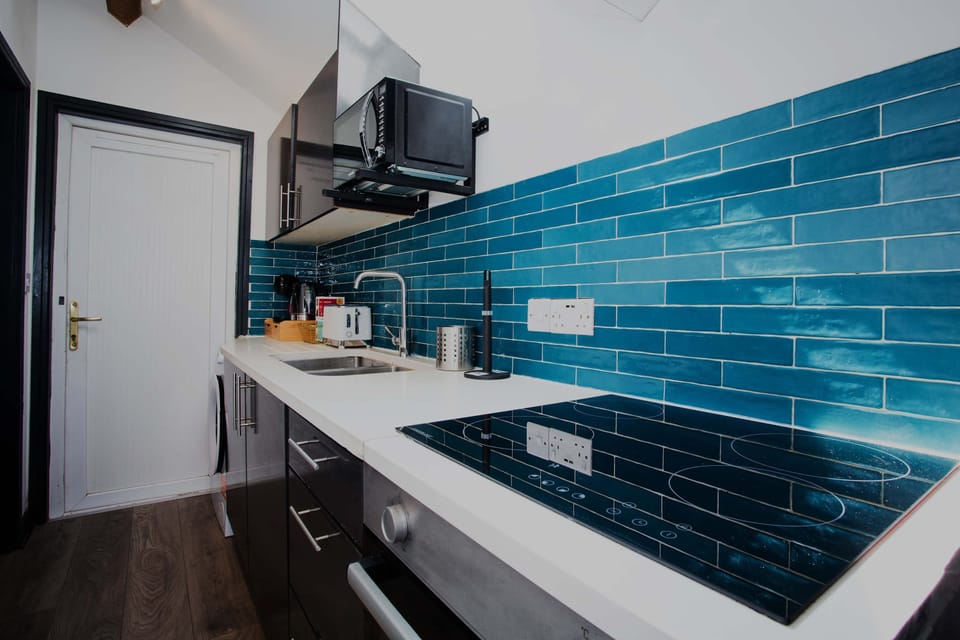 Fully kitted out kitchen with appliances, cooking utensils and cookware