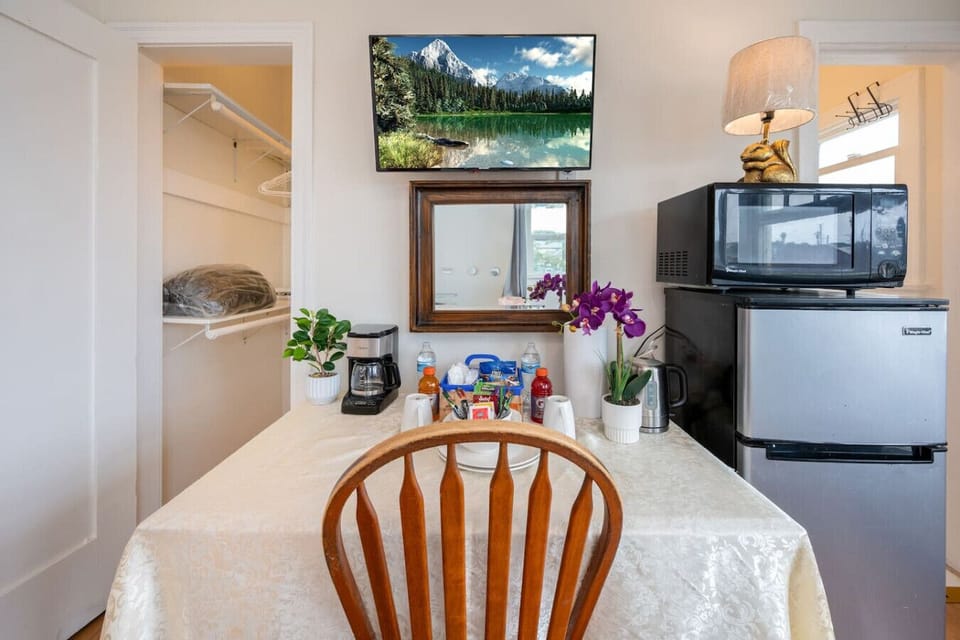 This fully furnished studio includes a private work desk, high-speed Wi-Fi, Smart TV for streaming, refrigerator, microwave, window air conditioning, ceiling fan, blackout curtains, complimentary snacks, and additional essentials to ensure a comfortable a