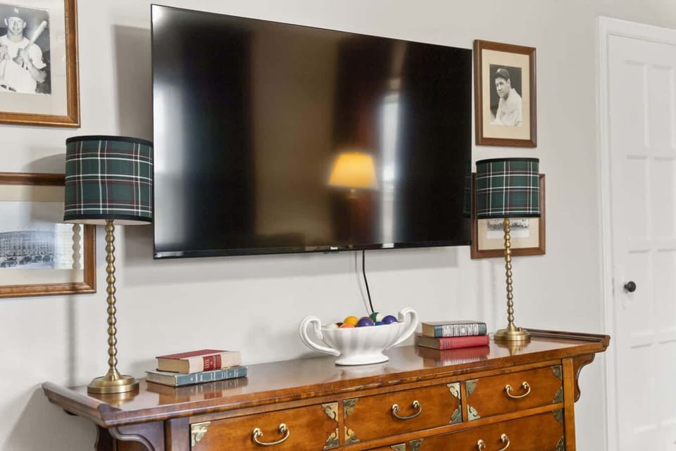 Entertainment nook w/ large TV, media console & cozy setup for movie nights.