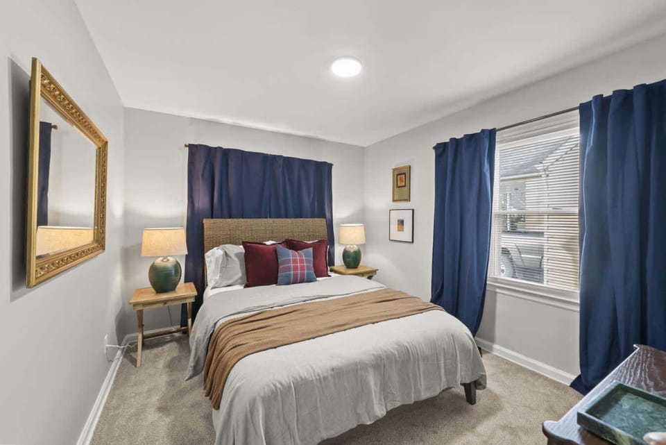 Comfortable bedroom w/ soft bedding, warm accents & a calm setup for restful nights.