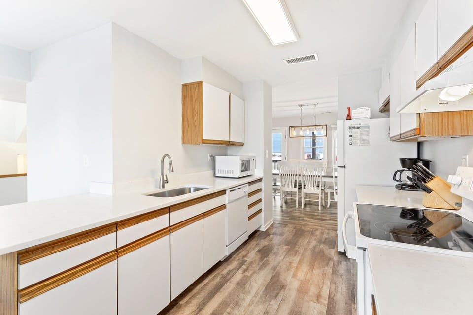 Fully Equipped Kitchen: Bright kitchen featuring full-size appliances, cookware, and ample counter space for easy meal preparation during your stay.
