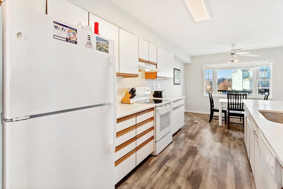 Fully Equipped Kitchen: Bright kitchen featuring full-size appliances, cookware, and ample counter space for easy meal preparation during your stay.