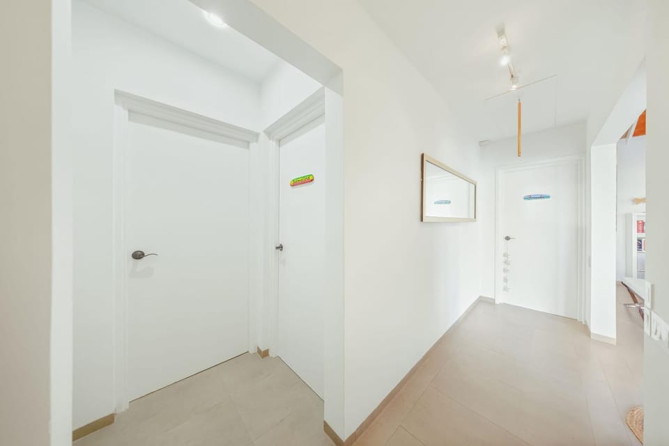 Bright hallway leading to cozy, air-conditioned bedrooms.