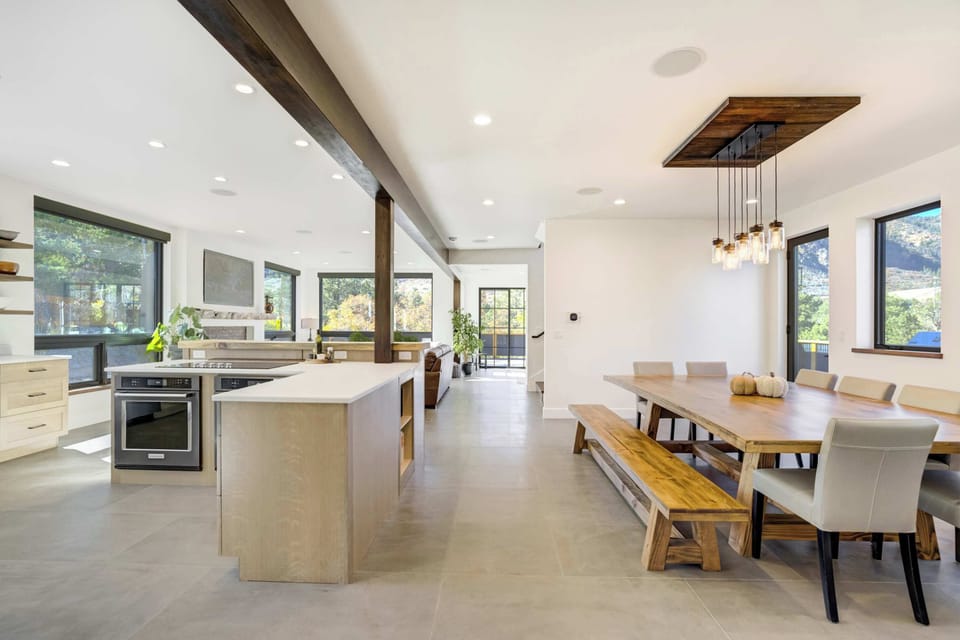 The open-concept kitchen and dining area bring everyone together with expansive windows, mountain views, and seamless flow for cooking and conversation.