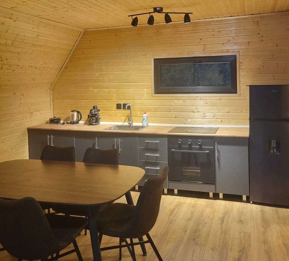 indoor dining, indoor, coffee and or coffee maker, kitchen, oven, stovetop.
