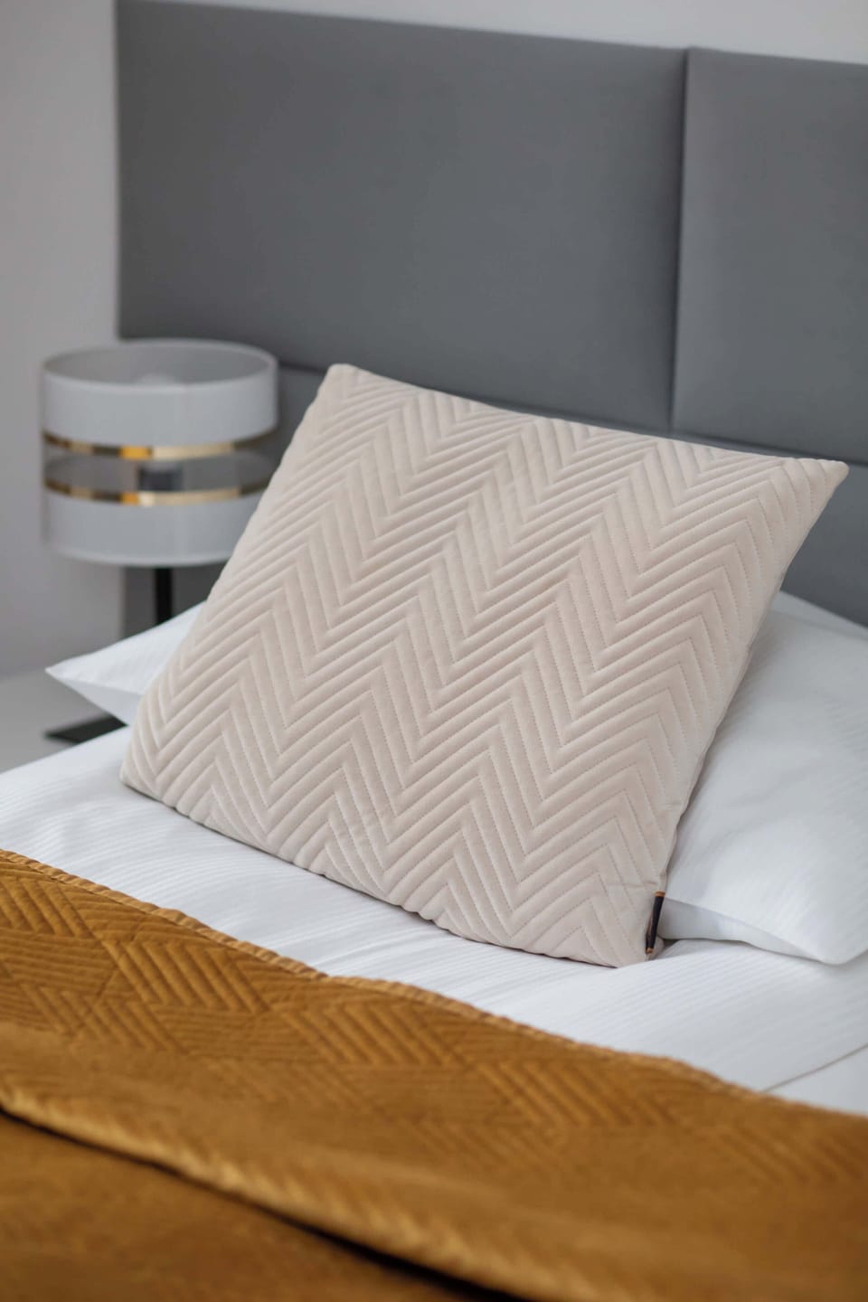 Minimalist bedroom with twin nightstands and reading lamps.