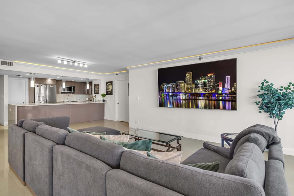 Bright living area with sectional sofa, and Smart TV