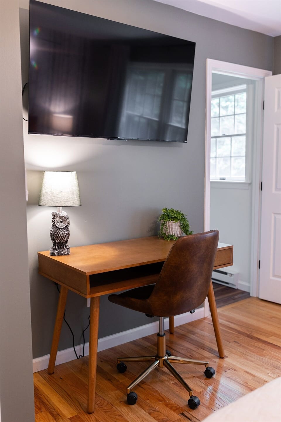 A desk and office chair is located within the Master Bedroom