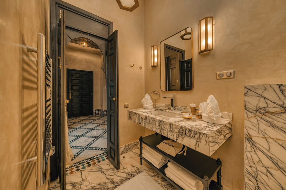 Executive Suite | Bathroom | Hair dryer, slippers, towels, soap