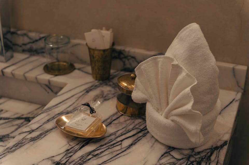 Executive Suite | Bathroom | Hair dryer, slippers, towels, soap