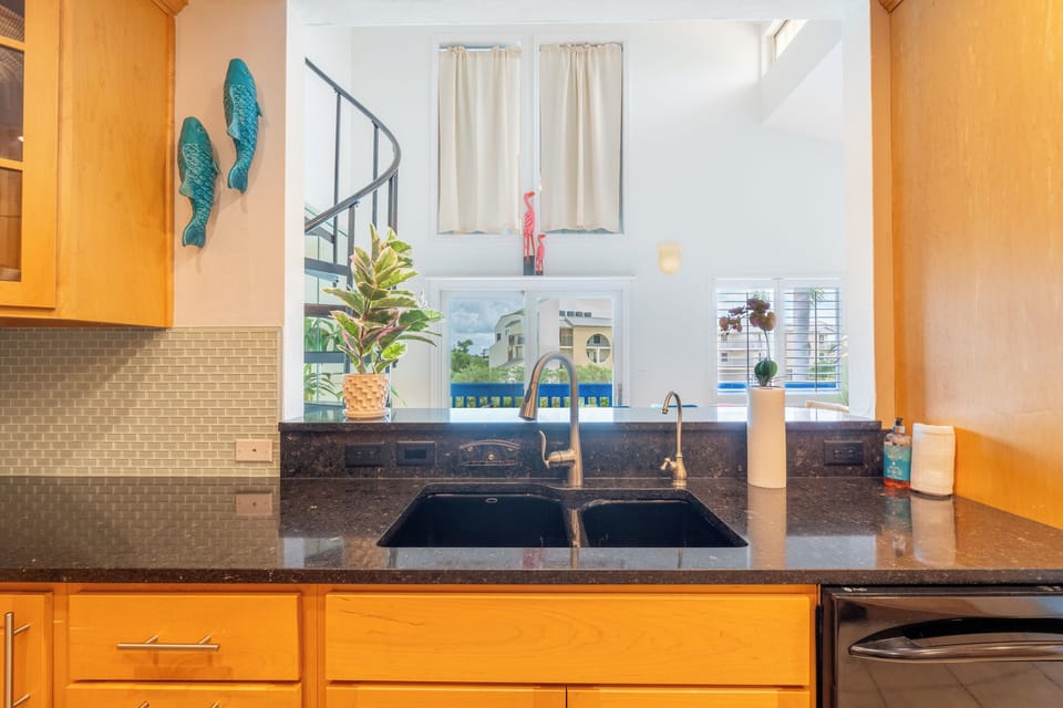 Kitchen under loft area across from dining area.