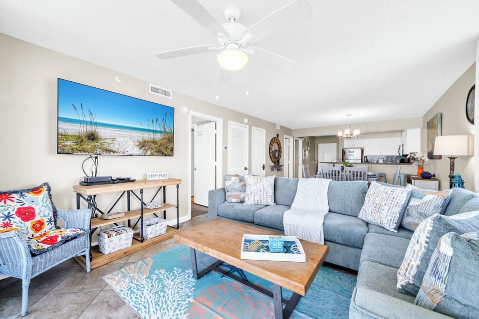 Relax in this coastal-inspired living space with comfy sectional seating and beach artwork that brings the ocean indoors.