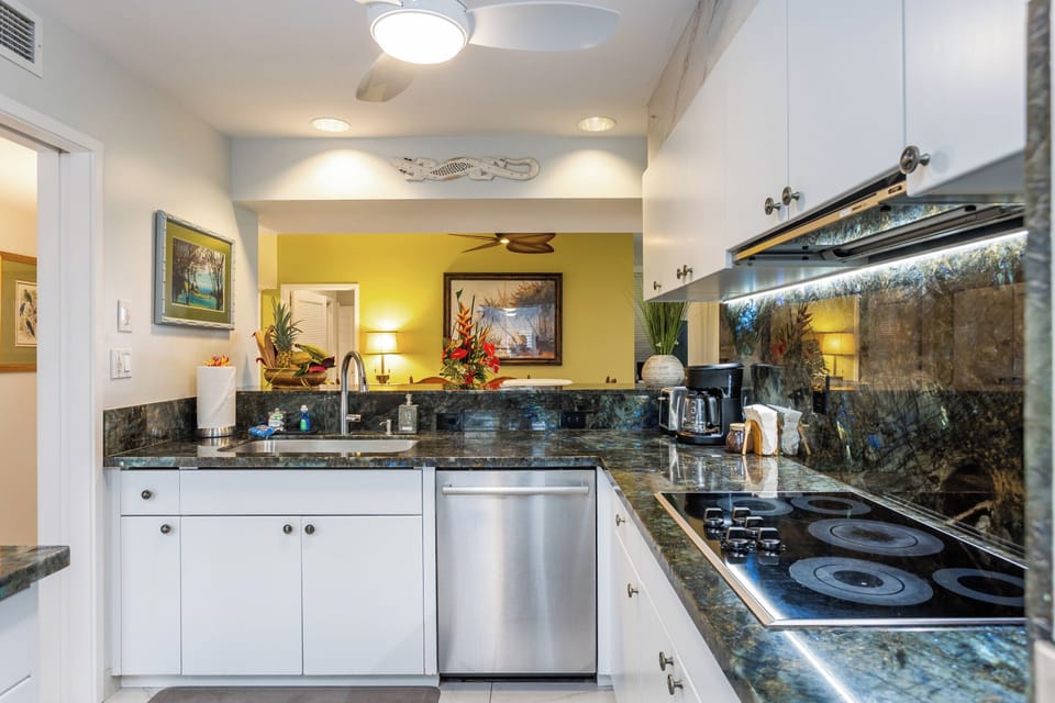Cook meals with ease in your fully equipped kitchen, featuring elegant granite counters, modern appliances, and charming tropical décor that makes you feel right at home.