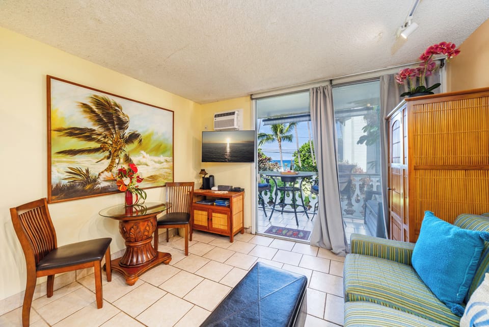 Relax in your cozy tropical retreat with island-inspired décor, ocean breezes, and a private lanai showcasing stunning ocean views just steps from your living room.