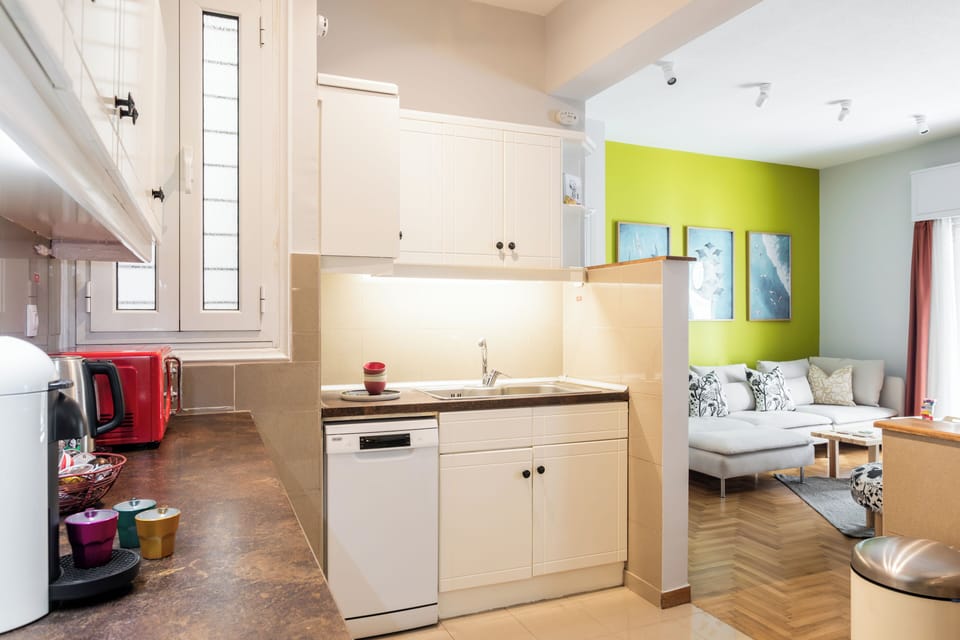 Fully equipped kitchen with a view of the living room; stay connected while cook