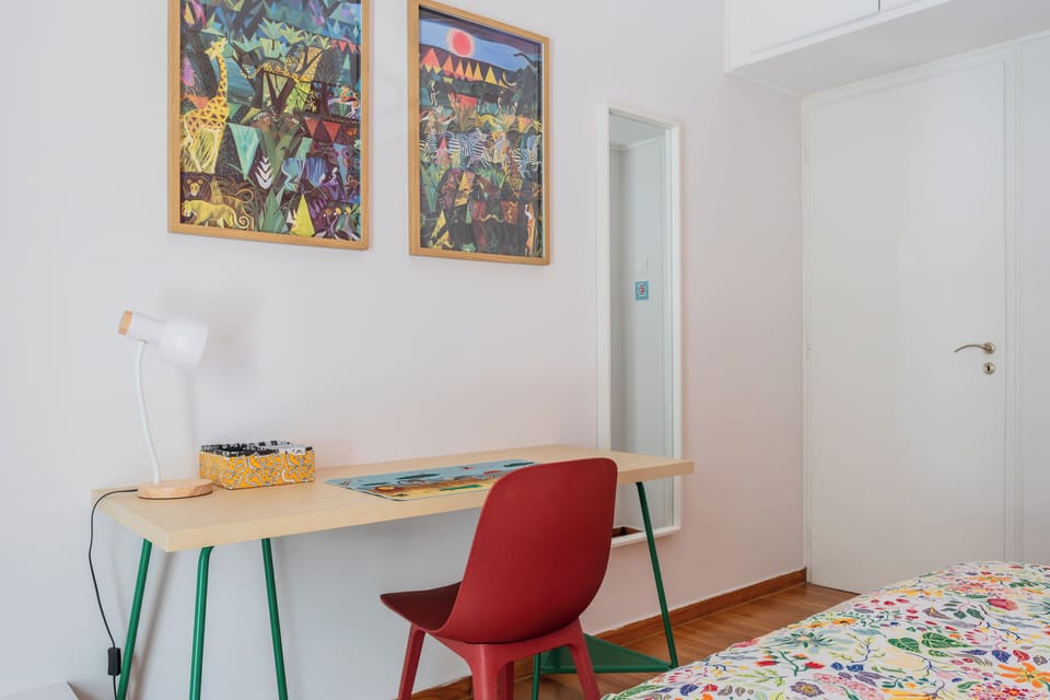 Comfortable workspace with desk, supportive chair, and adjustable lamp.